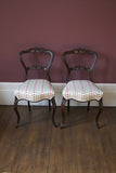 A pair of stunning Victorian side chairs, traditionally reupholstered and covered in Osborne and Little fabric.