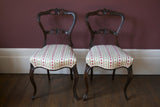 A pair of stunning Victorian side chairs, traditionally reupholstered and covered in Osborne and Little fabric.