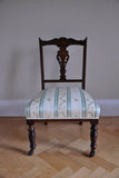 Edwardian Nursing Chair traditionally upholstered and finished in a vintage fabric.  This pretty Edwardian mahogany nursing chair has a delicate marquetry inlay.